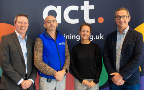 Richard Spear, ACT with employers standing infront of an ACT banner.
