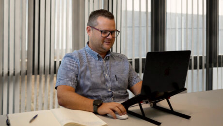 Nick Evans sitting in front of a computer.