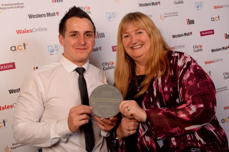 Liam Gill receives his award from Deputy Minister for Skills and Technology Julie James.