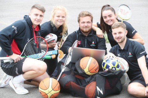 Rhodri Jones (centre), Urdd’s sports training officer, with apprentices Rhys Blacker, Caitlin Morgan, Rhodd-Alaw Parry and Jac Jenkins.