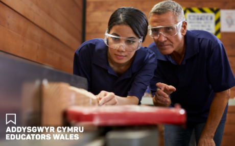 Female apprentice being given instruction by her tutor for carpentry