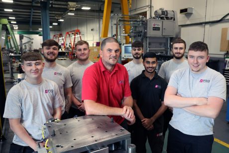Apprenticeships co-ordinator in factory with apprentices.