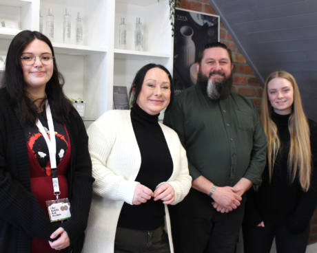 Owners Ruth and Alan standing in the shop with their apprentices Eleri and Eve