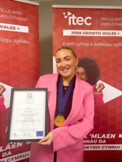 Katie Pearce holding her certificate.
