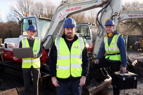 TRF ltd workers in high-vis jackets standing in front of digger 