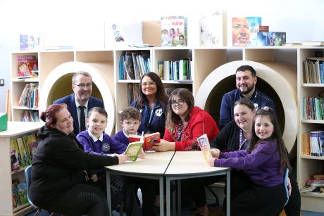 Achieve More Training's Sebastian Vidal and Leah Wilde with apprentices Ceri Tait, Ruby Rose and Rebecca Jenkins, acting headteacher David Thomas and young pupils at Ysgol Maes y Felin, Holywell.