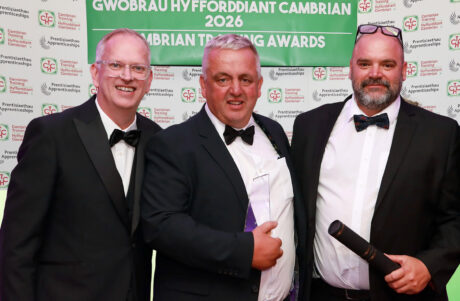Winners of the Medium Employer of the Year standing together with a member of staff from Cambrian Training.