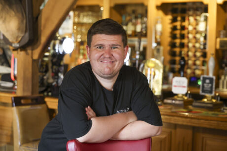 Aaron Jones standing in the bar area of the restaurant.