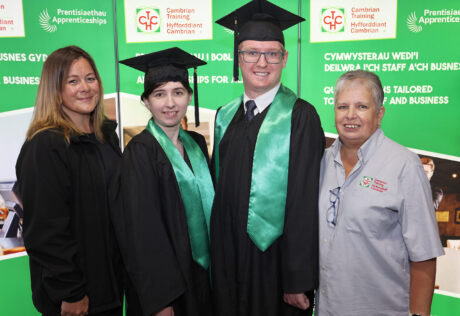 Apprentices in their cap and gowns at the graduation ceremony