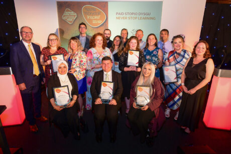 Inspire Awards winners on stage with Deputy Minister for Skills and Tertiary Education, Cefin Campbell.