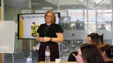 A tutor at the front of the class with learners